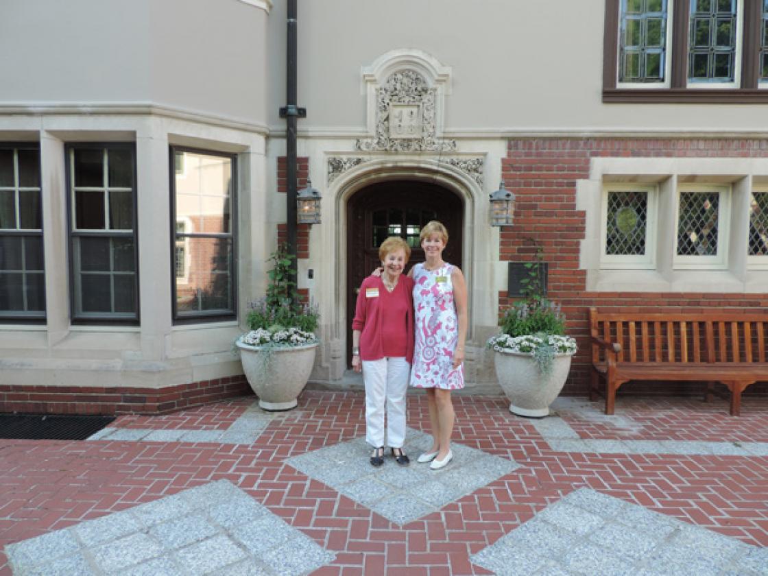 Photograph of two Cranbrook House & Gardens Auxiliary volunteer docents in front of Cranbrook House.