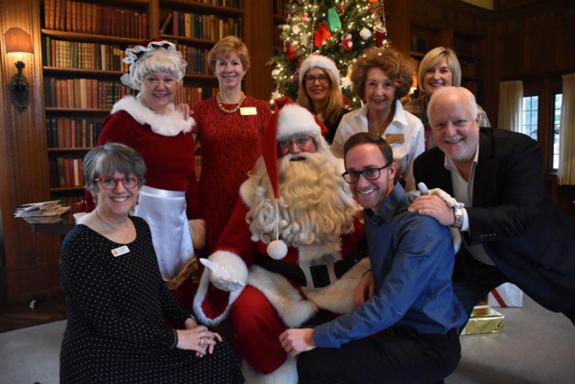 Photograph of volunteers with Santa in the Cranbrook House Library.