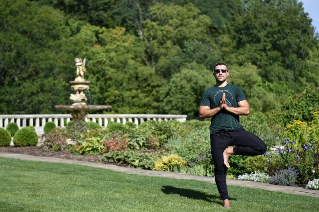 Photo of a Citizen Yoga instructor at Cranbrook Gardens by the Reflecting Pool.