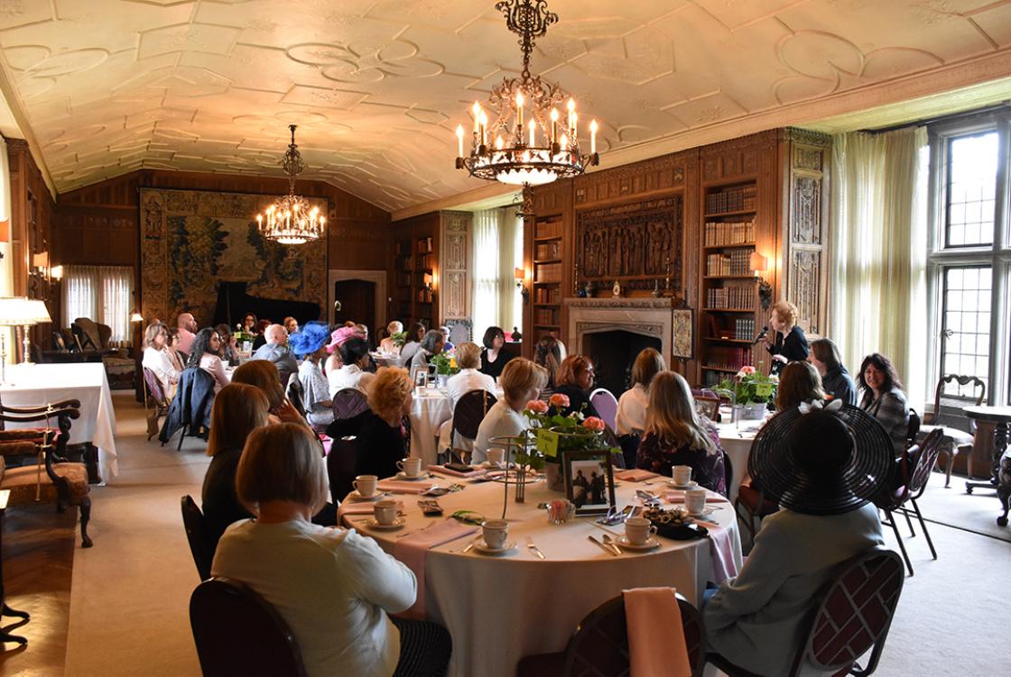 Photograph of guests in the Cranbrook House Library during a Mother's Day Tour & Tea, May 2019.